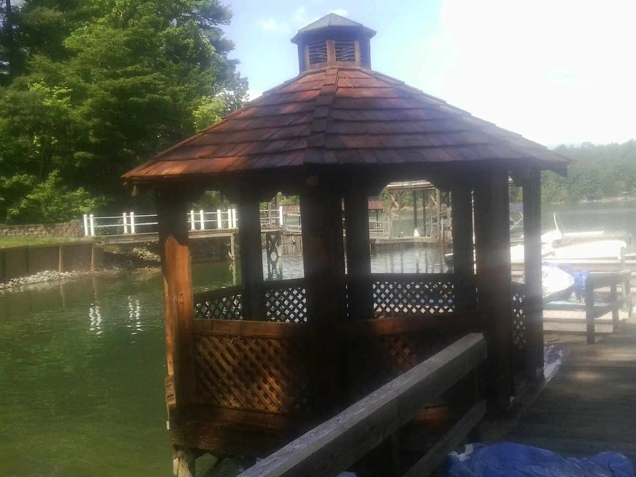 Cedar shake gazebo roof rebuilt on a lake dock in Mannsville